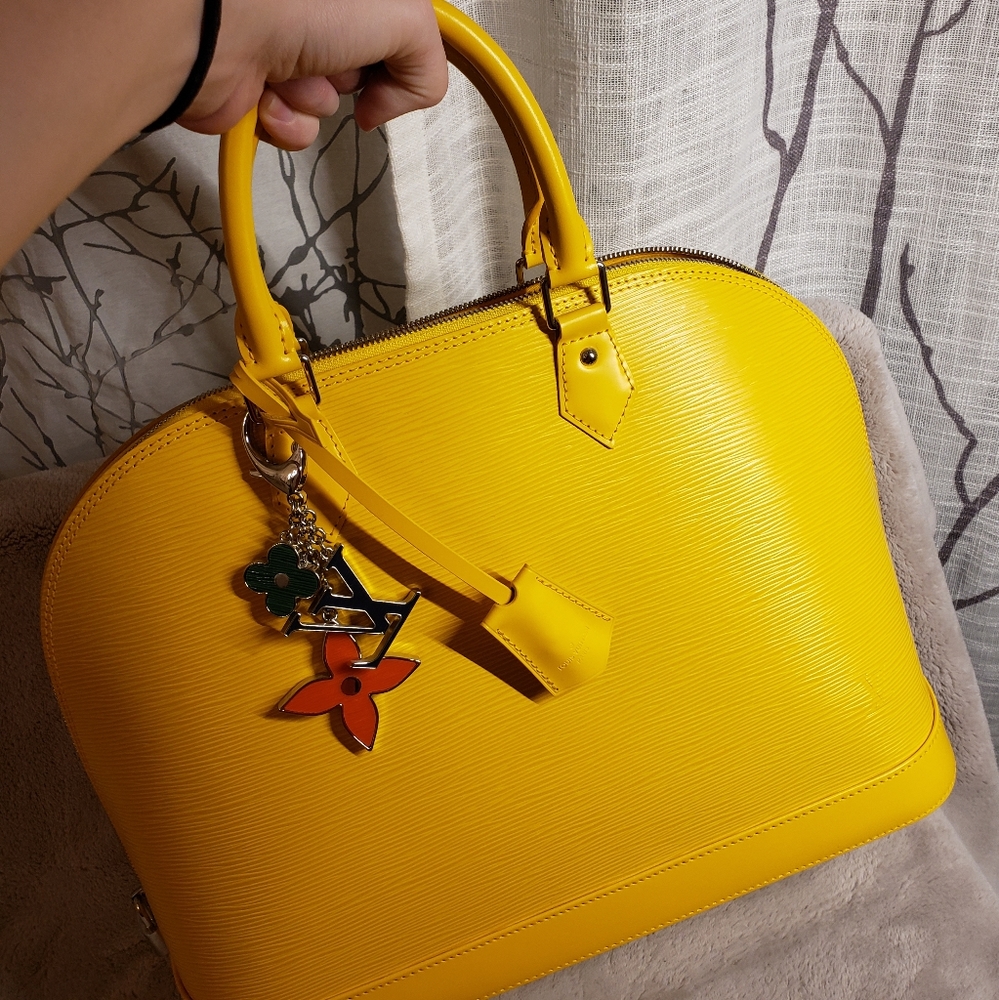 LV yellow EPI leather alma hang bag and a LV charm NEW